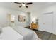 Bright bedroom with dark floors, features ceiling fan, and bedside tables at 1116 Ciandra Barn Way, Apex, NC 27523
