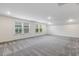 This bonus room features plush carpeting and windows that provide natural light at 1116 Ciandra Barn Way, Apex, NC 27523