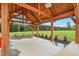 View of the community open air pavilion with lights, ceiling fan, concrete floor and brick wall at 1116 Ciandra Barn Way, Apex, NC 27523