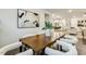 Dining area with wood table, white upholstered chairs, and view into kitchen and living spaces at 1116 Ciandra Barn Way, Apex, NC 27523