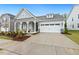 Charming home with a covered front porch, a two-car garage and attractive landscaping at 1116 Ciandra Barn Way, Apex, NC 27523