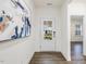 Elegant foyer with wood floors, large art piece, and view of the home's exterior through glass door at 1116 Ciandra Barn Way, Apex, NC 27523