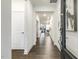 Bright hallway with hardwood floors and views into the dining and living areas at 1116 Ciandra Barn Way, Apex, NC 27523
