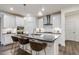 Bright kitchen with stainless steel appliances, stylish pendant lighting, and an island with seating at 1116 Ciandra Barn Way, Apex, NC 27523