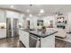 Open kitchen with a large island, stainless steel appliances, and seamless flow to living area at 1116 Ciandra Barn Way, Apex, NC 27523