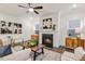 Inviting living room featuring a cozy fireplace, stylish decor, and comfortable seating at 1116 Ciandra Barn Way, Apex, NC 27523