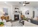 Well-lit living room with a fireplace, modern decor, and comfortable seating arrangement at 1116 Ciandra Barn Way, Apex, NC 27523