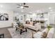 Open-concept living room with kitchen in background, modern furnishings, and neutral tones at 1116 Ciandra Barn Way, Apex, NC 27523