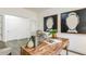 Bright office space featuring a wood desk, artistic decor, and neutral-toned furnishings at 1116 Ciandra Barn Way, Apex, NC 27523