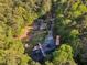 Extensive property featuring tennis court, surrounded by lush greenery, with a long driveway and space for outdoor activities at 11209 Sedgefield Dr, Raleigh, NC 27613