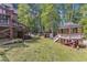 Large backyard featuring a deck, covered swing, shed, and gazebo, surrounded by lush greenery at 11209 Sedgefield Dr, Raleigh, NC 27613