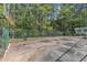 Fenced basketball court with hoops and pavement, perfect for recreation and sports activities at 11209 Sedgefield Dr, Raleigh, NC 27613