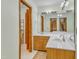 Bathroom with double sinks, vanity cabinets, and view to a second room at 11209 Sedgefield Dr, Raleigh, NC 27613