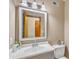 Well-lit bathroom with a white vanity, decorative mirror, and updated sink faucet at 11209 Sedgefield Dr, Raleigh, NC 27613