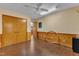 This bedroom has light colored walls, wood paneled walls, hardwood floors and a fan at 11209 Sedgefield Dr, Raleigh, NC 27613