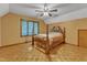 Bedroom with hardwood floors, a four-poster bed, and a window with natural light at 11209 Sedgefield Dr, Raleigh, NC 27613