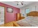 Comfortable bedroom with a dresser, natural light, and doorway to the bathroom at 11209 Sedgefield Dr, Raleigh, NC 27613