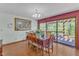 Elegant dining room with wood floors, a decorative chandelier, and sliding doors to a private deck at 11209 Sedgefield Dr, Raleigh, NC 27613