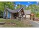 Features a wooden and stone exterior with a gravel driveway at 11209 Sedgefield Dr, Raleigh, NC 27613