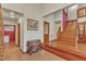 Inviting foyer with beautiful wood staircase and flooring, complemented by neutral walls and decorative accents at 11209 Sedgefield Dr, Raleigh, NC 27613