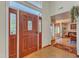 Inviting front foyer with beautiful wood door and side windows, tile floor, and views into the home at 11209 Sedgefield Dr, Raleigh, NC 27613