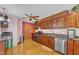 Cozy kitchen featuring wood cabinets, granite countertops, and stainless steel appliances at 11209 Sedgefield Dr, Raleigh, NC 27613