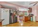 Bright kitchen featuring stainless steel refrigerator and view to the dining area at 11209 Sedgefield Dr, Raleigh, NC 27613