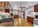 Charming kitchen with wooden cabinets, granite countertops, and a view of the backyard through a bright window at 11209 Sedgefield Dr, Raleigh, NC 27613