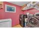 Functional laundry room with washer, dryer, a freezer, and practical shelving for storage at 11209 Sedgefield Dr, Raleigh, NC 27613
