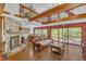 Spacious living room boasting a stone fireplace, an elegant sofa, and a view of the dining area at 11209 Sedgefield Dr, Raleigh, NC 27613