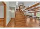 Bright living room featuring a staircase, wood floors, and a glimpse of the dining area at 11209 Sedgefield Dr, Raleigh, NC 27613