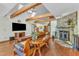 Cozy living room with exposed wood beams, skylights, and a stone fireplace, creating a warm atmosphere at 11209 Sedgefield Dr, Raleigh, NC 27613
