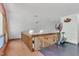 Upper loft area features natural light, exercise equipment, and wood railing at 11209 Sedgefield Dr, Raleigh, NC 27613