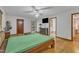 Well-lit main bedroom with hardwood floors and ceiling fan at 11209 Sedgefield Dr, Raleigh, NC 27613
