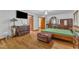 Bright main bedroom with hardwood floors, leather ottoman, and ample storage at 11209 Sedgefield Dr, Raleigh, NC 27613