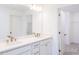 Bathroom boasts double sink vanity, large mirror, and storage; entry to walk-in closet at 113 Sepals Pl, Wendell, NC 27591
