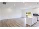 Open-concept living room with modern flooring, recessed lighting, and access to the kitchen island at 113 Sepals Pl, Wendell, NC 27591