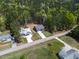 Aerial view of the home nestled on a large lot surrounded by mature trees at 115 Buckskin Dr, Louisburg, NC 27549