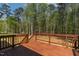 Stained wood back deck overlooking a private backyard with a lush green space at 115 Buckskin Dr, Louisburg, NC 27549