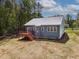 Exterior home with a wood deck and yard with grass and trees at 115 Buckskin Dr, Louisburg, NC 27549