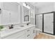 Bright bathroom featuring a double sink vanity, modern fixtures, and a glass-enclosed shower at 115 Buckskin Dr, Louisburg, NC 27549