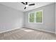 Well-lit bedroom with carpet floors and a large window letting in natural light at 115 Buckskin Dr, Louisburg, NC 27549