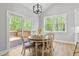 Bright dining area with sliding door access to the deck and views of the surrounding greenery at 115 Buckskin Dr, Louisburg, NC 27549