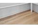 Close-up of light wood flooring, showing the texture, grain, and clean lines against the white wall at 115 Buckskin Dr, Louisburg, NC 27549