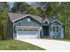 Beautiful exterior of home with blue siding, white garage door, and well-manicured lawn at 115 Buckskin Dr, Louisburg, NC 27549