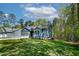 Charming home with blue siding, attached garage, and a lush green front yard at 115 Buckskin Dr, Louisburg, NC 27549