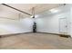 A spacious two-car garage features a clean, concrete floor and a white door leading to the outside at 115 Buckskin Dr, Louisburg, NC 27549