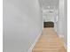 Bright hallway featuring luxury vinyl plank flooring, white trim, and an open view to the living room at 115 Buckskin Dr, Louisburg, NC 27549