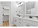 Elegant main bathroom featuring double vanities, modern fixtures, and a walk-in closet at 115 Buckskin Dr, Louisburg, NC 27549