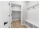 Bright mudroom with storage, coat rack and a view into the laundry room at 115 Buckskin Dr, Louisburg, NC 27549